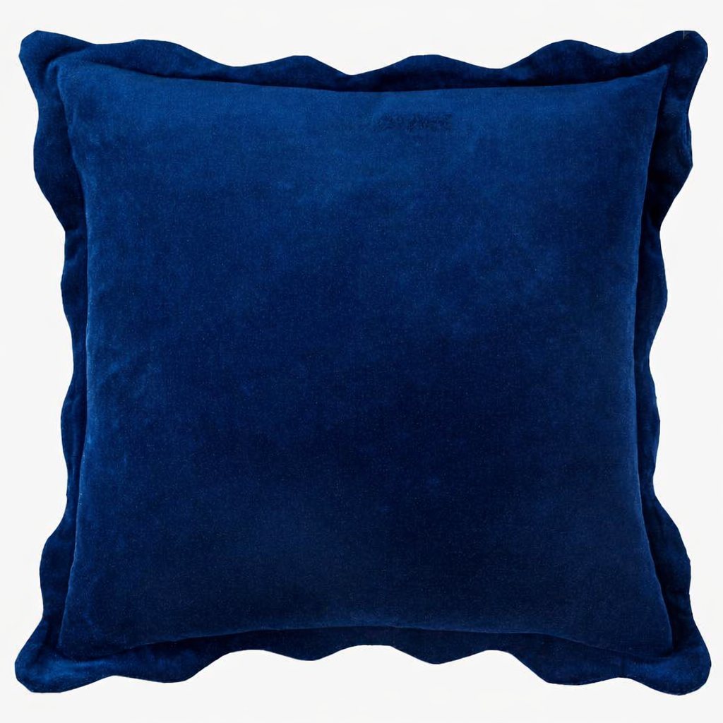 Navy velvet pillow with soft scalloped edges and a plush, rich texture.