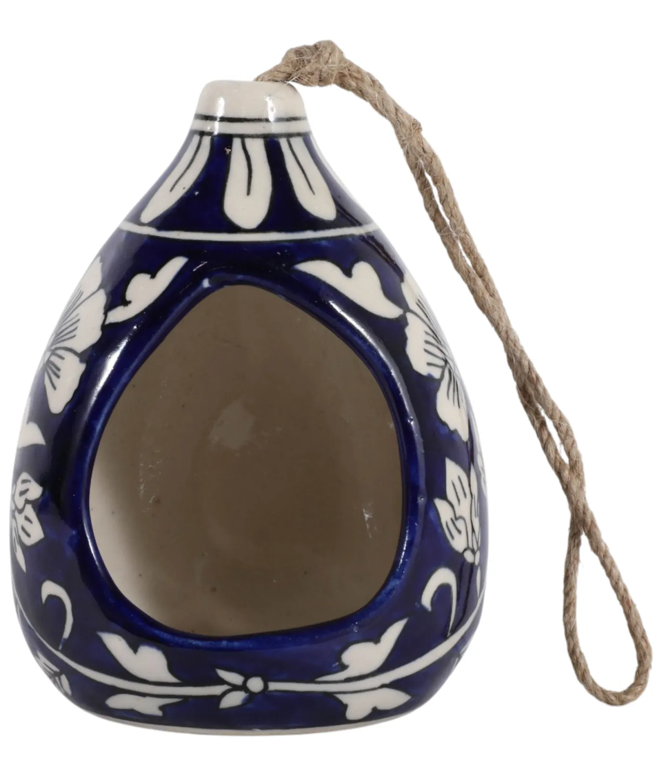   
blue ceramic teardrop bird feeder with white floral pattern and natural rope hanger