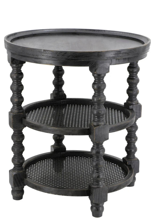 Round black side table with turned legs and two cane shelves.