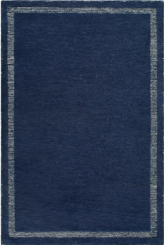 dark navy woven rug corner with light border, minimalist coastal design