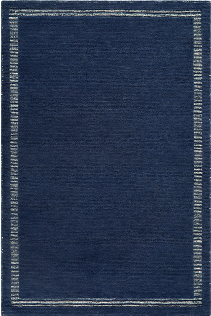 dark navy woven rug corner with light border, minimalist coastal design