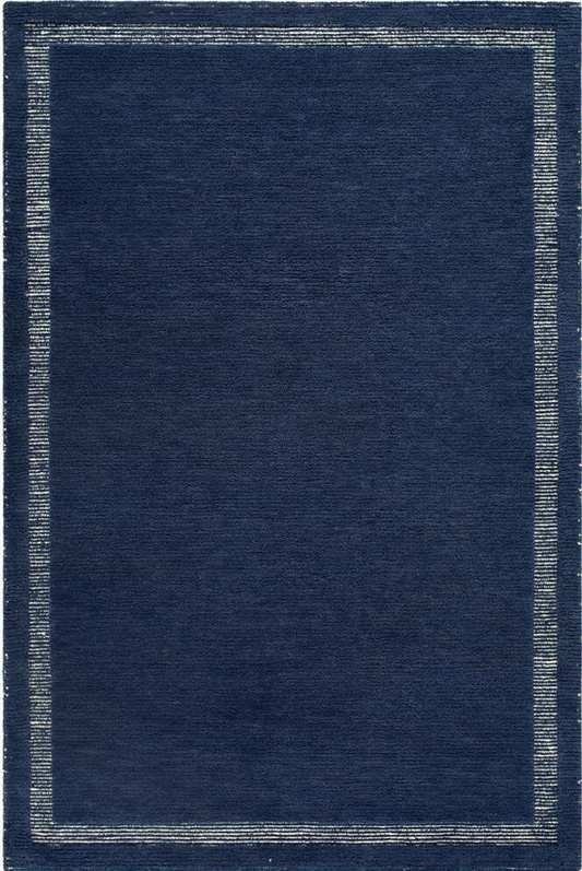 dark navy woven rug corner with light border, minimalist coastal design