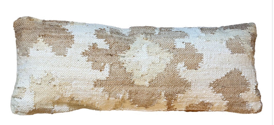 Rectangular woven pillow with south Asian‑inspired neutral pattern and textured detailing.