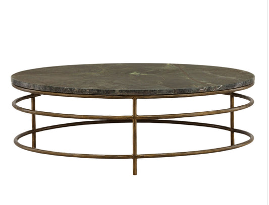 round stone top coffee table with sculptural iron ring base and warm metal finish, modern contemporary living room furniture, statement living room, stone and iron coffee table.