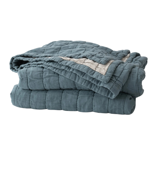 Slate channeled cotton quilt folded neatly, showing soft texture and casual everyday weight.