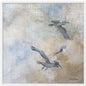 soft neutral coastal canvas wall art featuring two seabirds in flight against a muted blue, beige, and ivory background.