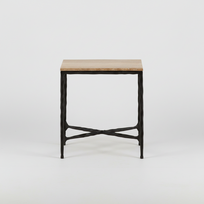 Iron side table with a textured black metal frame and a rectangular stone top, featuring crossed metal supports near the base.