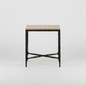 Iron side table with a textured black metal frame and a rectangular stone top, featuring crossed metal supports near the base.