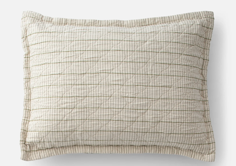 Heirloom‑inspired pillow sham with muted beige and olive‑green stripes, quilted diamond texture, and a relaxed flat edge