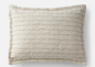 Heirloom‑inspired pillow sham with muted beige and olive‑green stripes, quilted diamond texture, and a relaxed flat edge